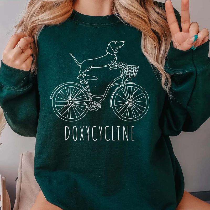 Doxycycline Pharmacy Pun T-shirt - Pharmacists Sweatshirt, Dachshund on Bicycle, Perfect Gift for Pharmacists & Technicians sweatshirts